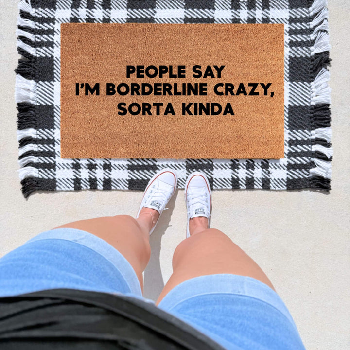 Lil Wayne 6 Foot 7 Foot inspired doormat featuring “People Say I’m Borderline Crazy, Sorta Kinda” in bold black lettering on natural coir.