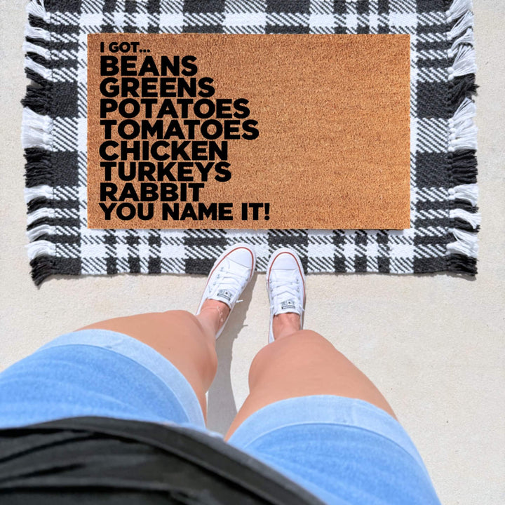 Funny Thanksgiving doormat featuring “I Got Beans, Greens, Potatoes, Tomatoes, Chicken, Turkeys, Rabbit, You Name It!” in bold black lettering on natural coir.
