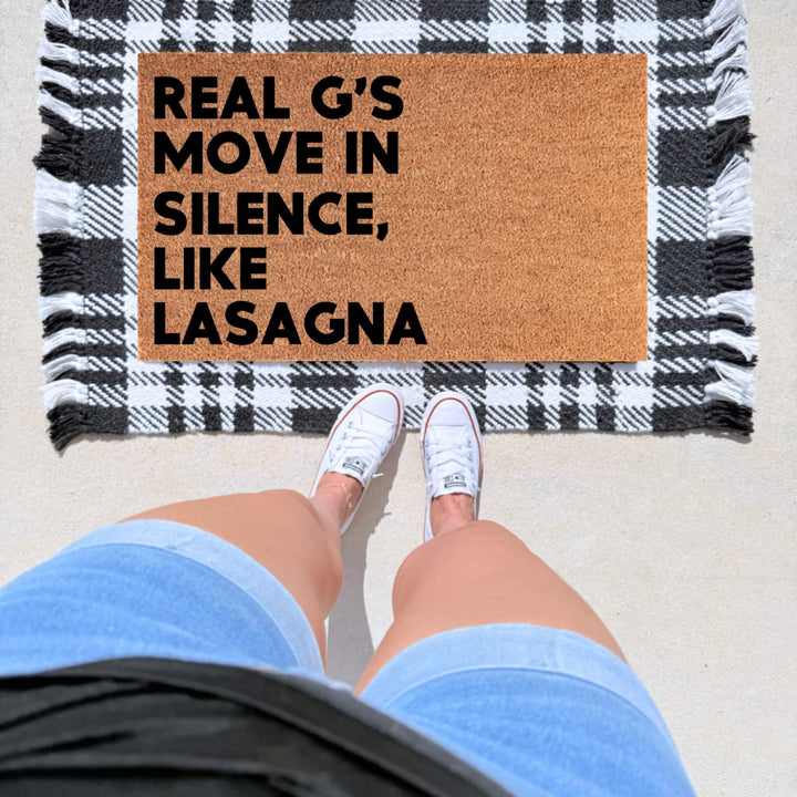 Lil Wayne 6 Foot 7 Foot inspired doormat featuring “Real G’s Move In Silence, Like Lasagna” in bold black lettering on natural coir.
