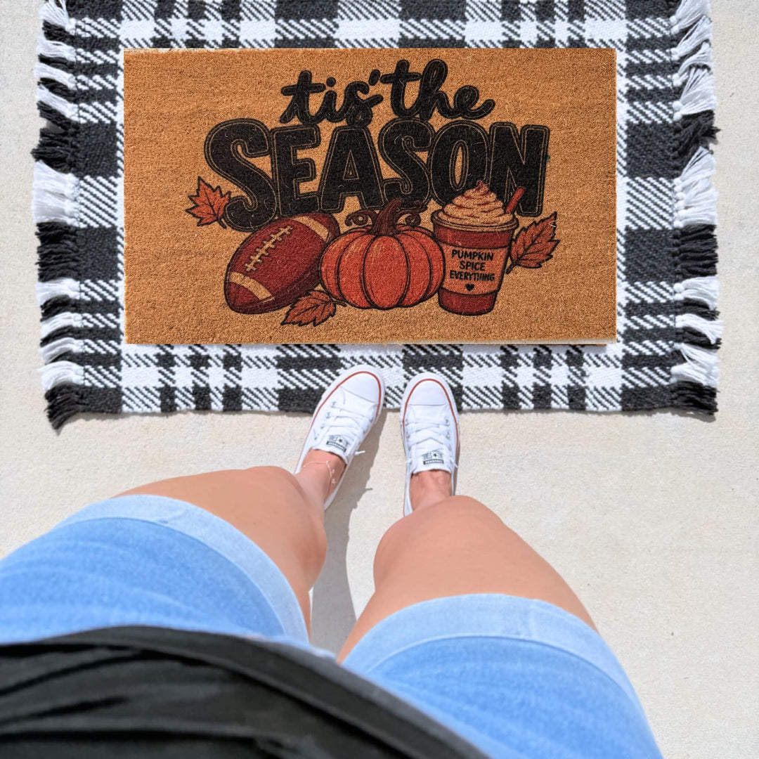 Fall coir doormat featuring "Tis the Season" with a football, pumpkin, autumn leaves, and pumpkin spice latte for cozy autumn front porch décor.