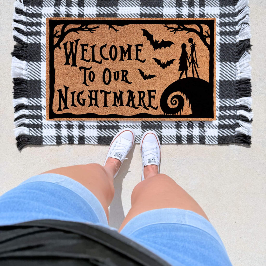 Spooky Welcome to Our Nightmare Halloween doormat featuring bats, creepy silhouettes, and gothic details on a natural coir mat for Halloween front porch décor. Jack Skellington. The nightmare before Christmas 