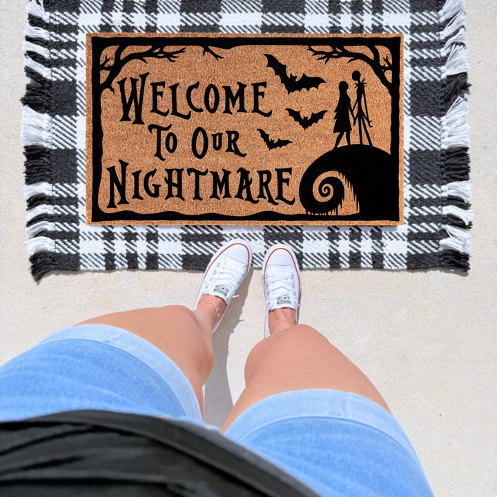 Spooky Welcome to Our Nightmare Halloween doormat featuring bats, creepy silhouettes, and gothic details on a natural coir mat for Halloween front porch décor. Jack Skellington. The nightmare before Christmas 